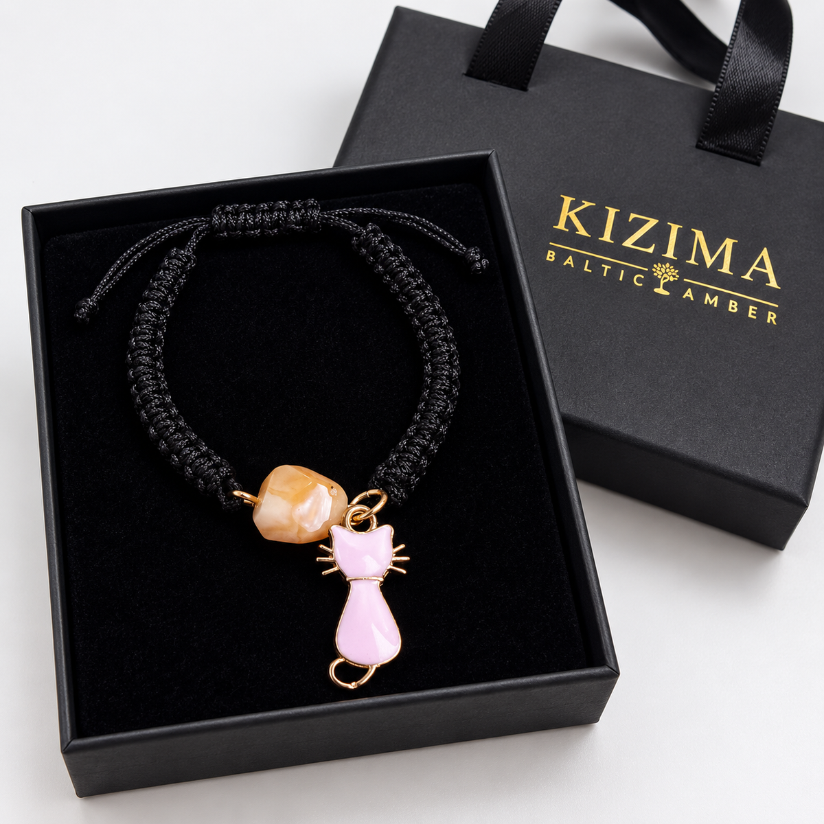 KIZIMA 3G0125q2.76-3 pale peach amber black macrame bracelet with pink cat charm in a black KIZIMA gift box with gold logo