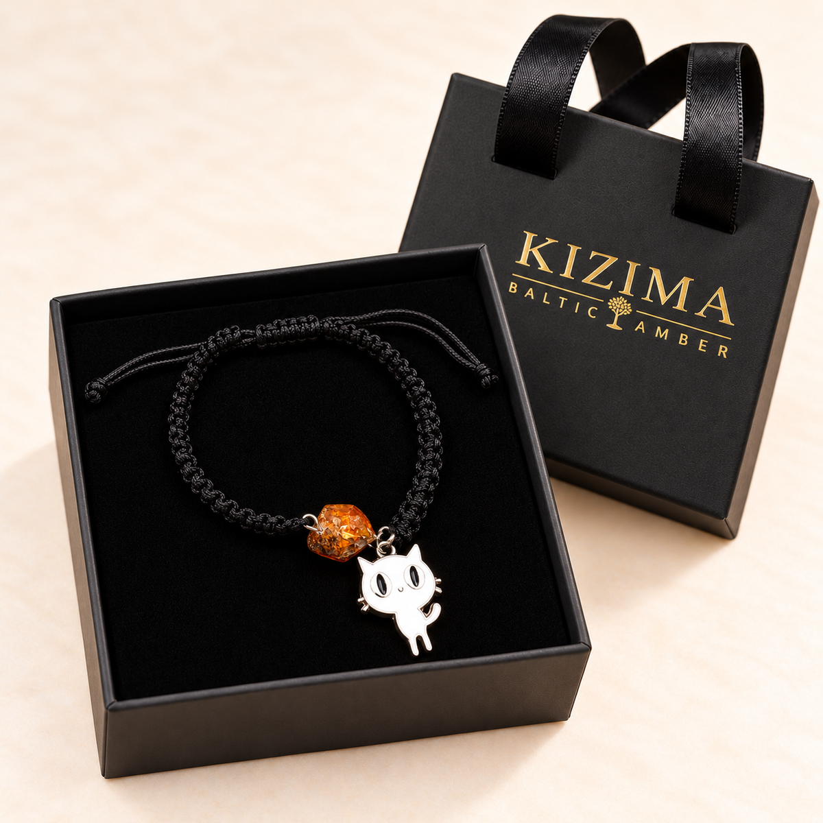 Amber and white cat charm bracelet presented in a KIZIMA box with pristine black velvet