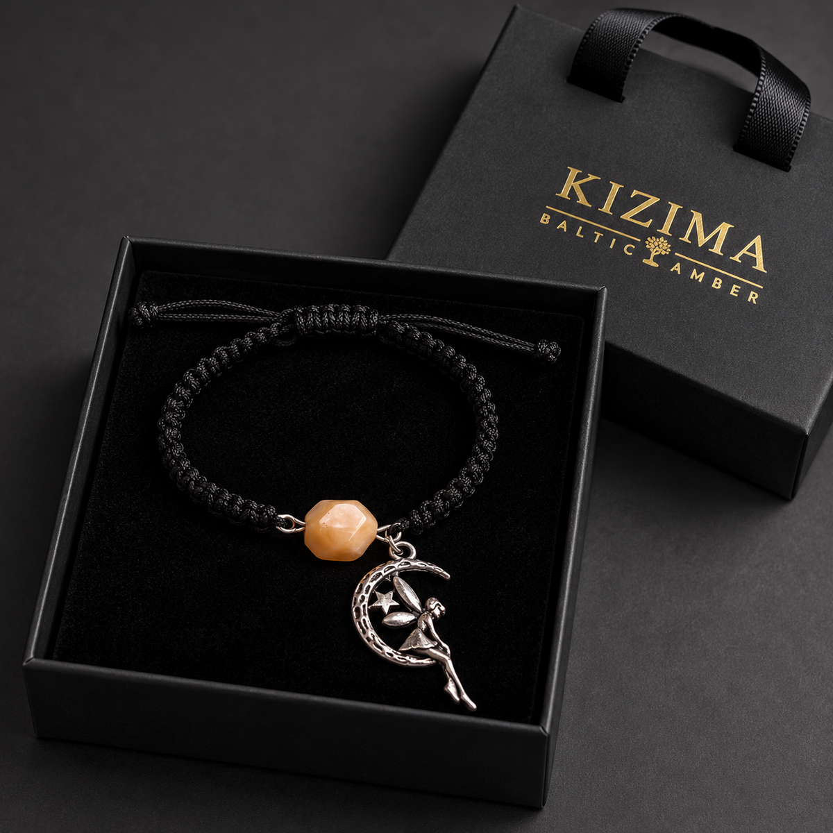 KIZIMA single creamy amber bead and silver-tone moon fairy bracelet in a black KIZIMA gift box with clean black velvet