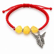 Yellow amber and red macrame bracelet with a silver-colored winged angel pendant, isolated on white.