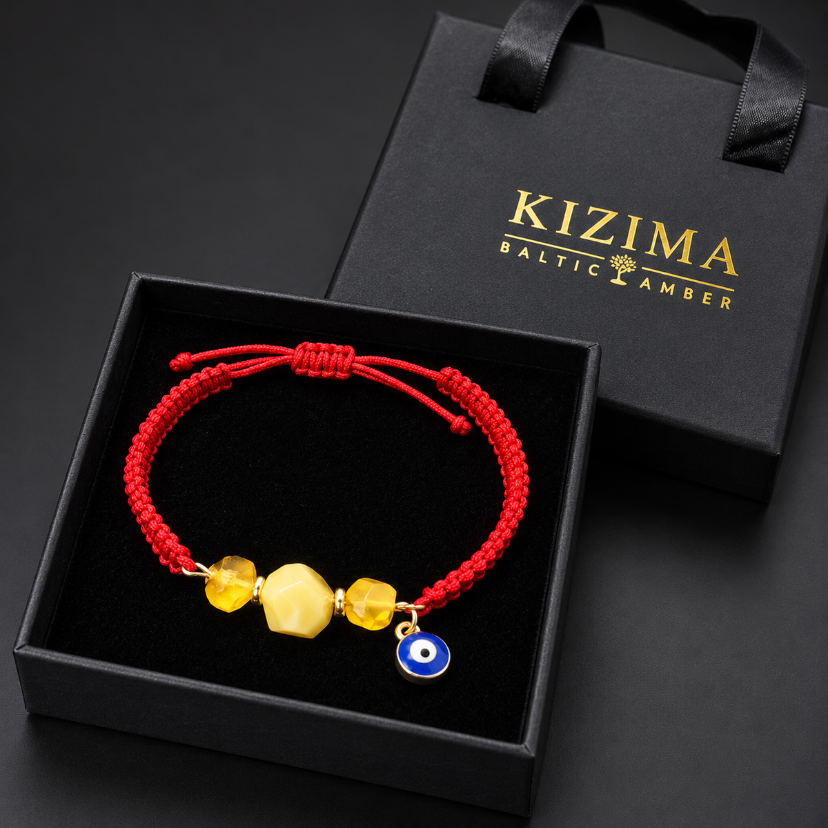 KIZIMA 3G0125q2.81-7 three-bead yellow and honey amber red macrame bracelet with blue evil-eye charm in the KIZIMA black velvet gift box