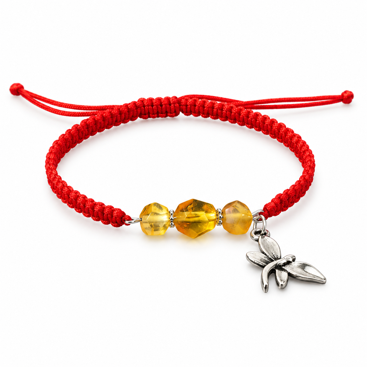Red adjustable macrame bracelet with three transparent golden amber beads and a dragonfly charm on white