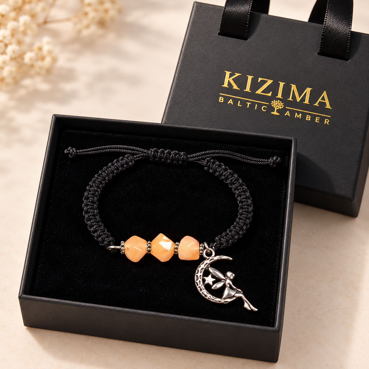KIZIMA three peach amber stones and moon fairy charm bracelet in a black KIZIMA gift box