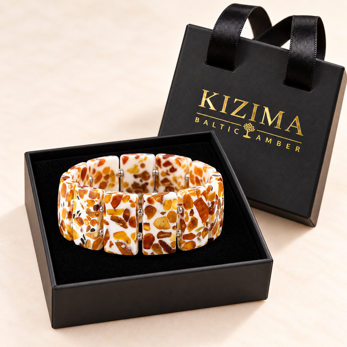 KIZIMA wide white and amber mosaic bracelet with silver-colored spacers on black velvet inside its handled-lid gift box