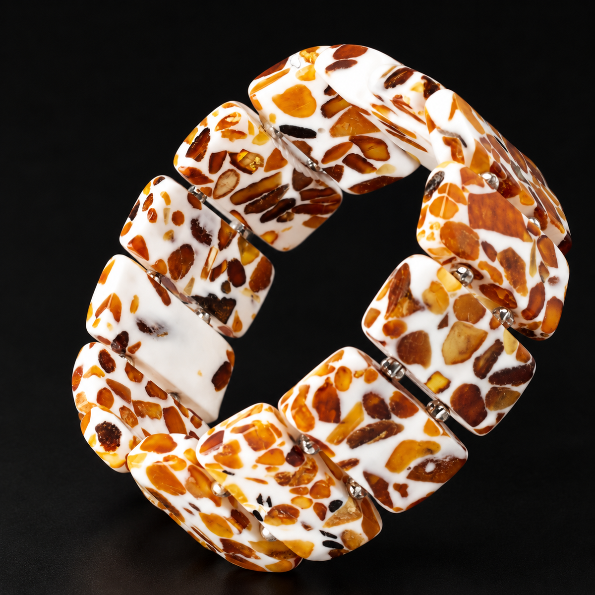 KIZIMA wide white and amber mosaic panel bracelet with paired silver-colored spacers in black studio light