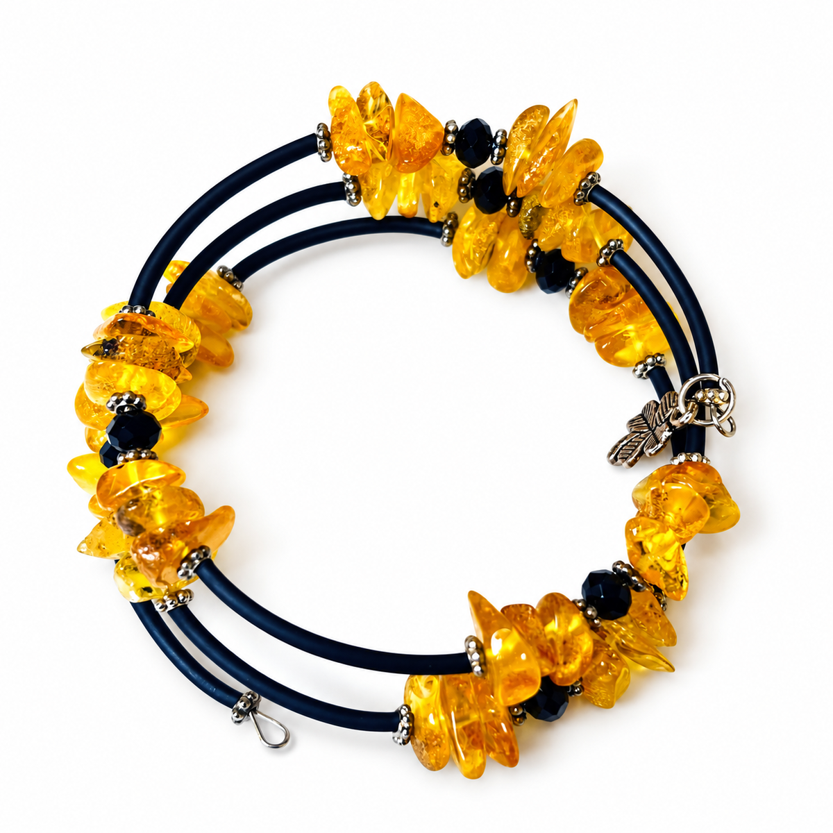 KIZIMA 3G250q16 three-coil spiral bracelet with yellow amber, dark navy sections and black faceted beads isolated against pure white