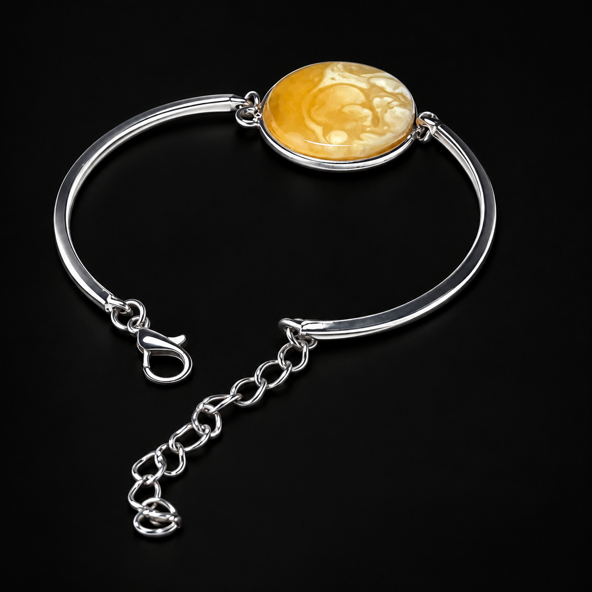 KIZIMA round marbled yellow amber cabochon in silver-tone semi-rigid bracelet in a black studio