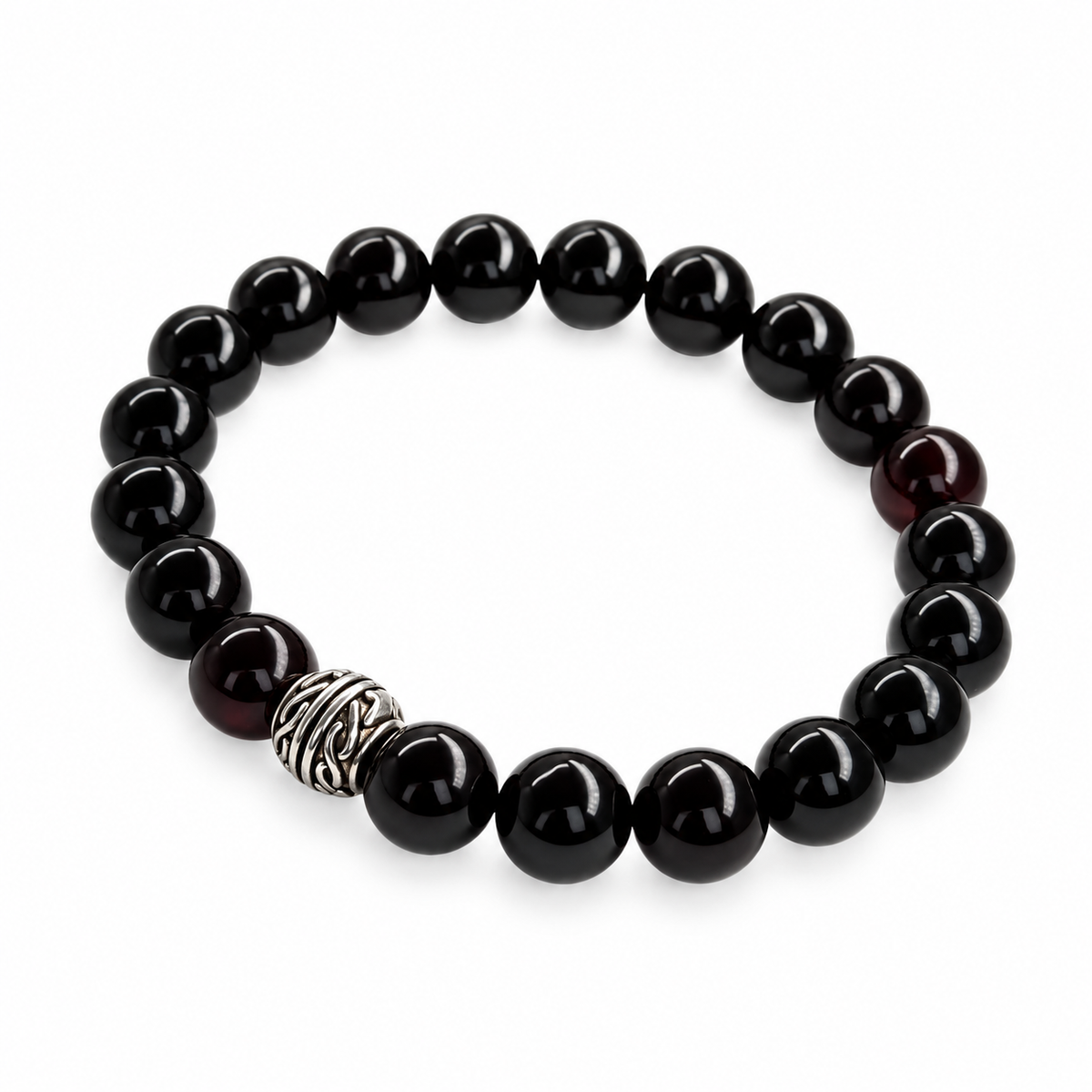KIZIMA black amber stretch bracelet with round beads and a patterned metal accent isolated on pure white.