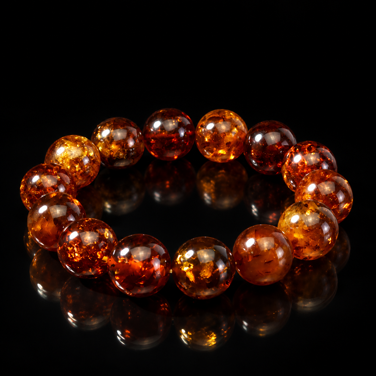 KIZIMA 3K0720q20.56.1 fourteen-bead cognac Baltic amber stretch bracelet on a black studio background.
