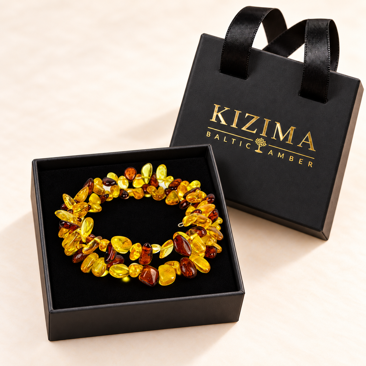 Yellow and cognac amber spiral bracelet on spotless black velvet in the branded KIZIMA gift box.