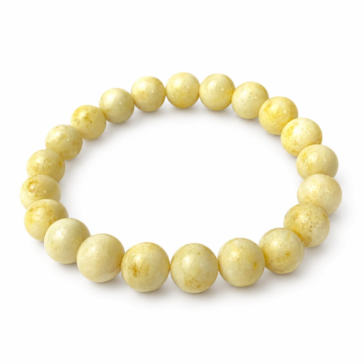 Twenty-one polished milky amber beads in a single-strand bracelet on pure white.