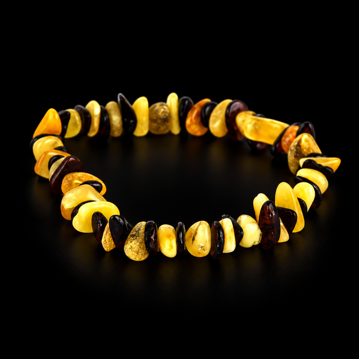 KIZIMA yellow and dark cherry amber chip stretch bracelet in premium black studio light.