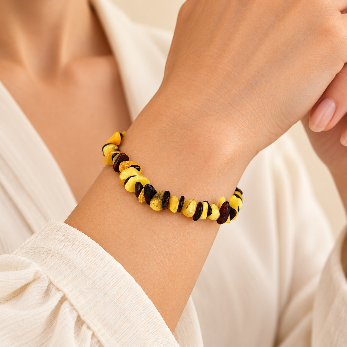 Alternating yellow and dark amber chip bracelet on a young adult woman's wrist.