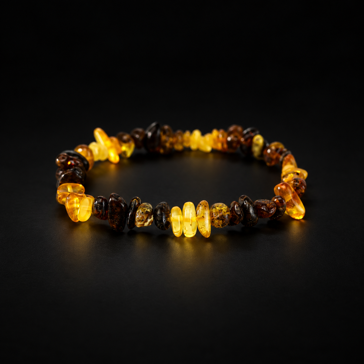 KIZIMA yellow and dark mottled amber nugget bracelet on a black studio background.