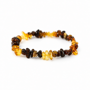 KIZIMA yellow and dark mottled amber nugget bracelet on a pure white background.