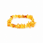 KIZIMA translucent yellow and honey amber chip bracelet on a pure white background.
