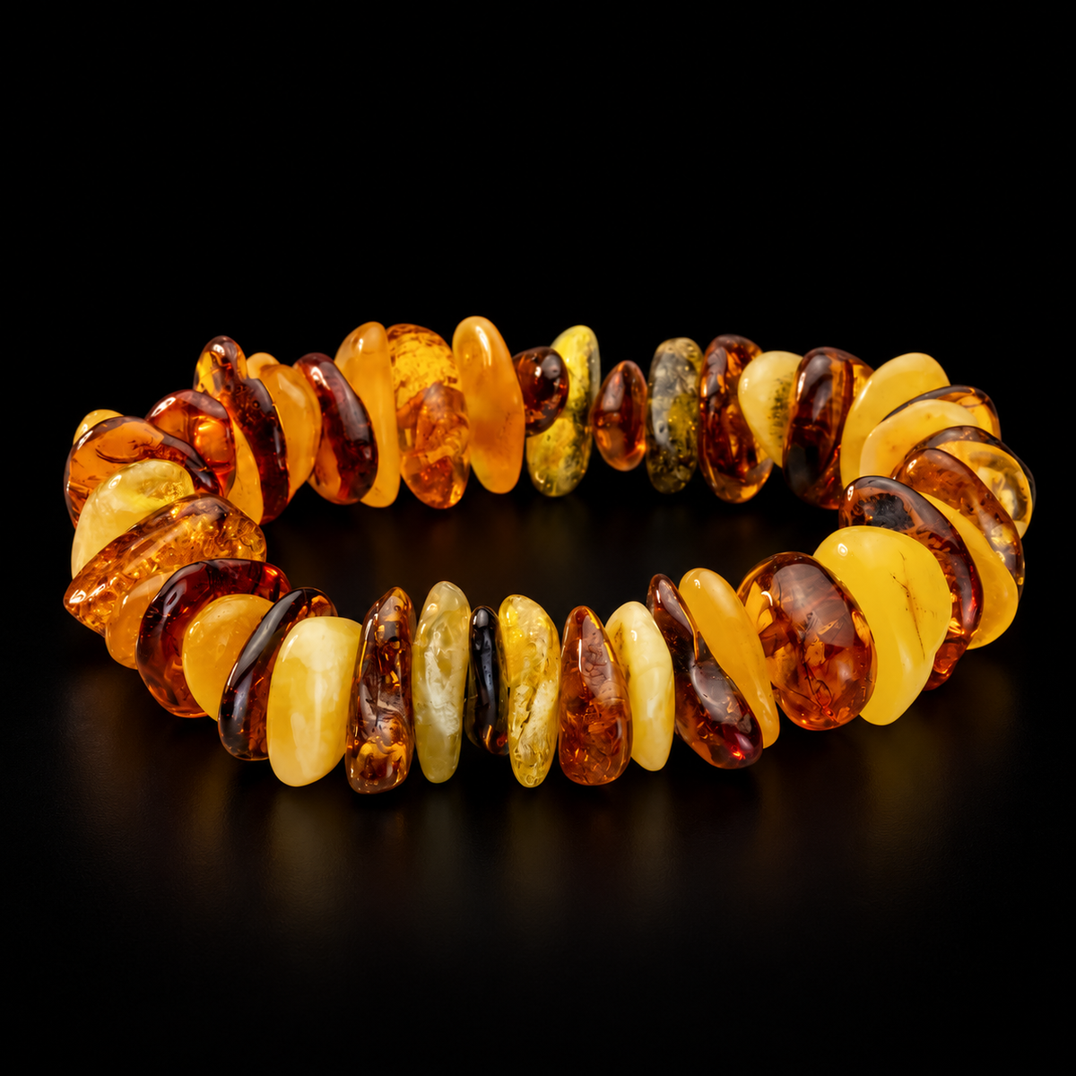 KIZIMA 3N0075q6.15.1 mixed-tone amber pebble bracelet on a black studio surface