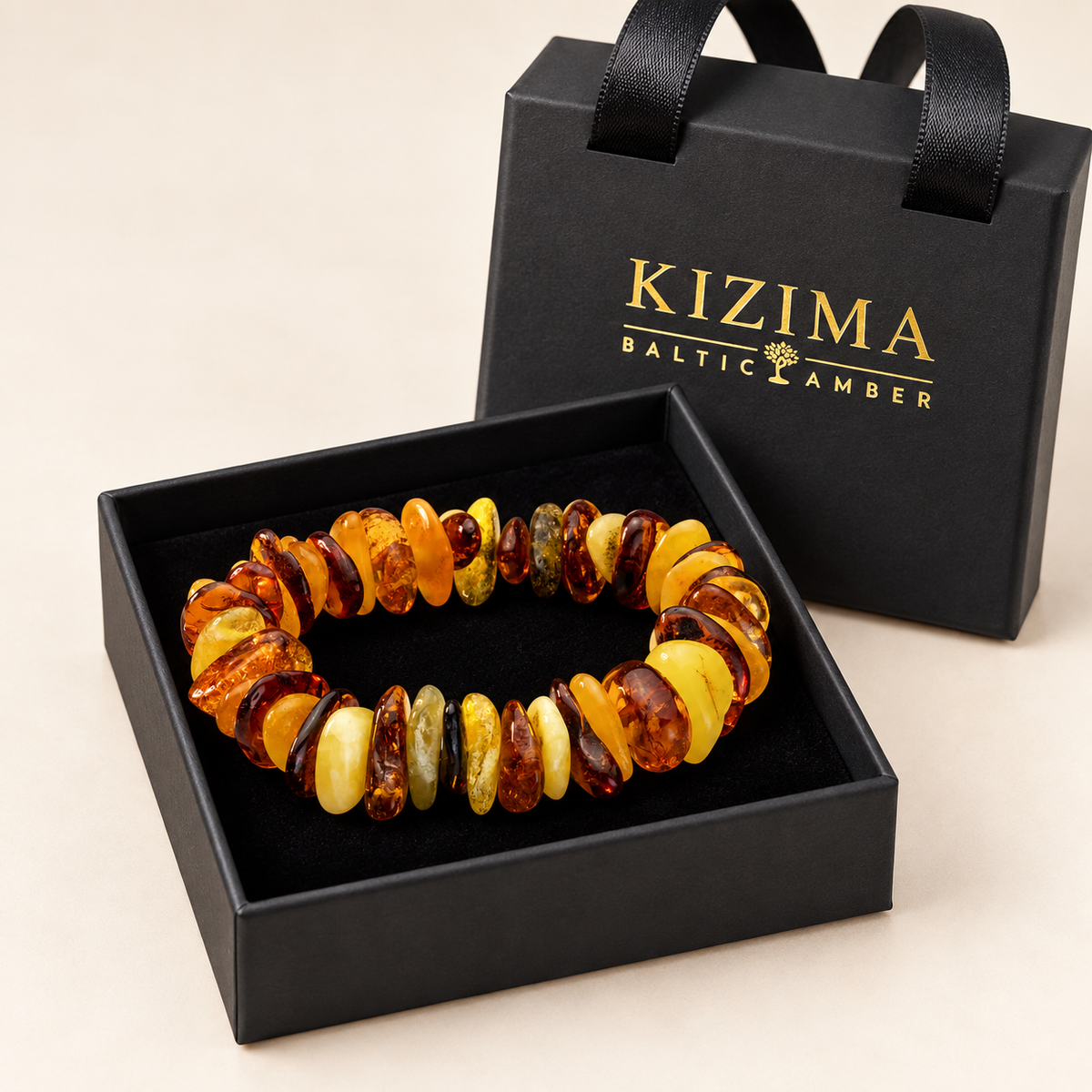 KIZIMA 3N0075q6.15.1 mixed-tone amber pebble bracelet on clean black velvet in its KIZIMA gift box