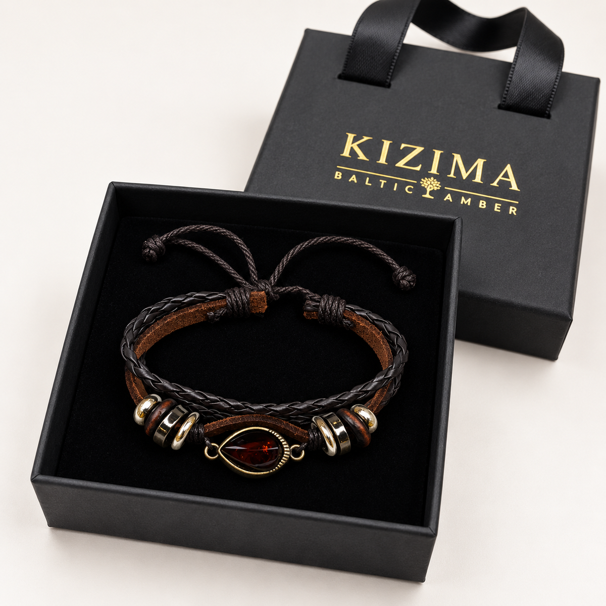 KIZIMA dark amber teardrop and brown braided leather bracelet in a KIZIMA gift box.