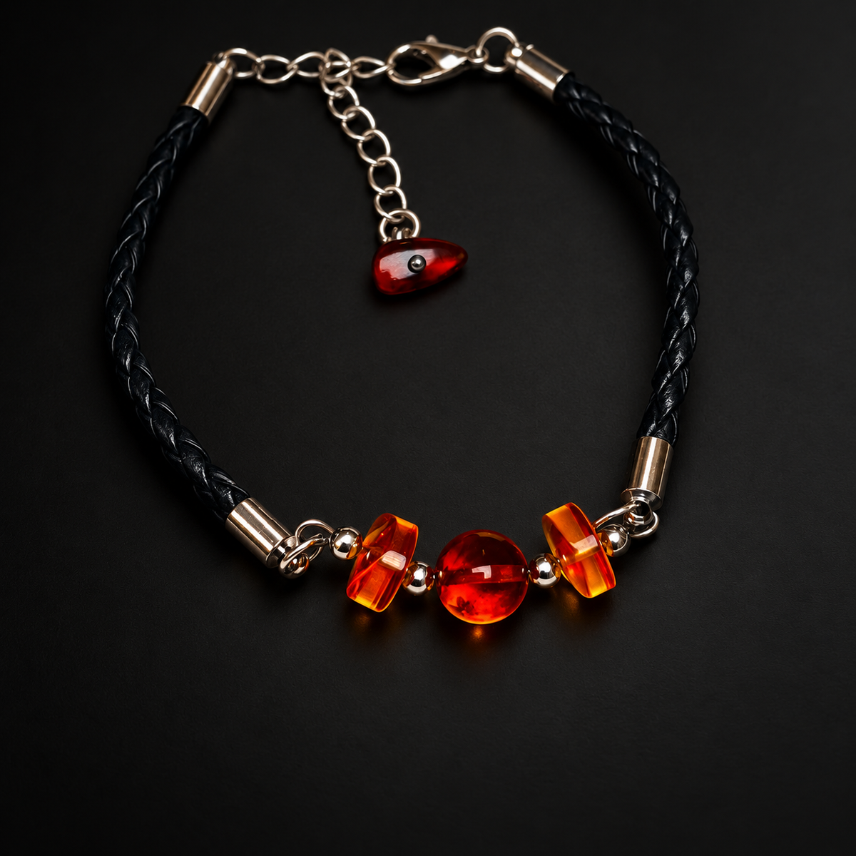 KIZIMA cherry amber three-bead black braided leather bracelet on a black studio background.