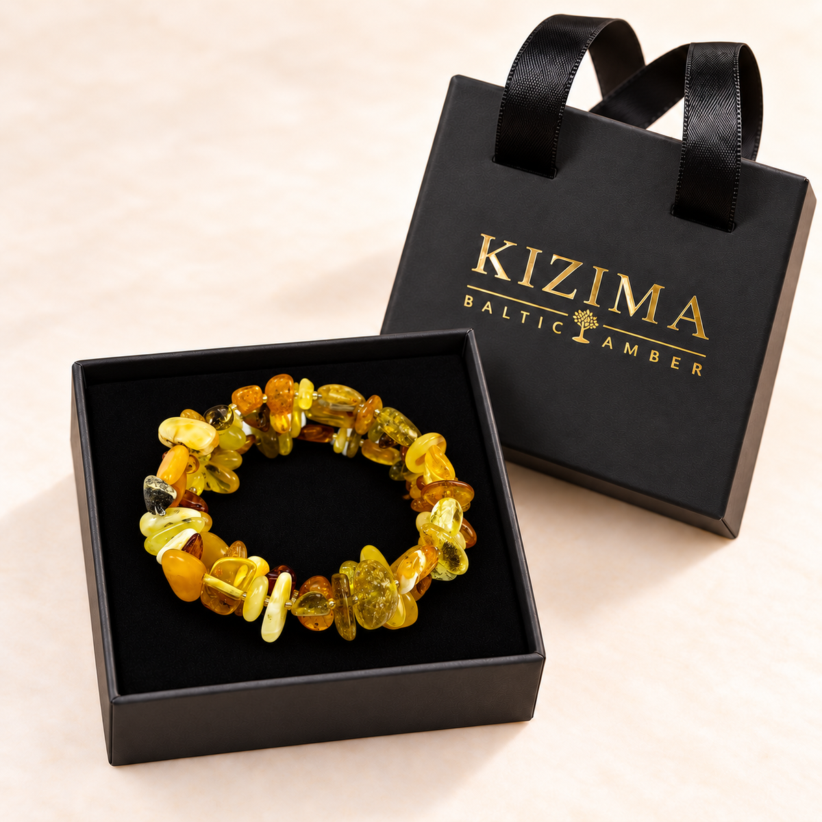 KIZIMA multicolor amber spiral bracelet resting on clean black velvet in its branded gift box.