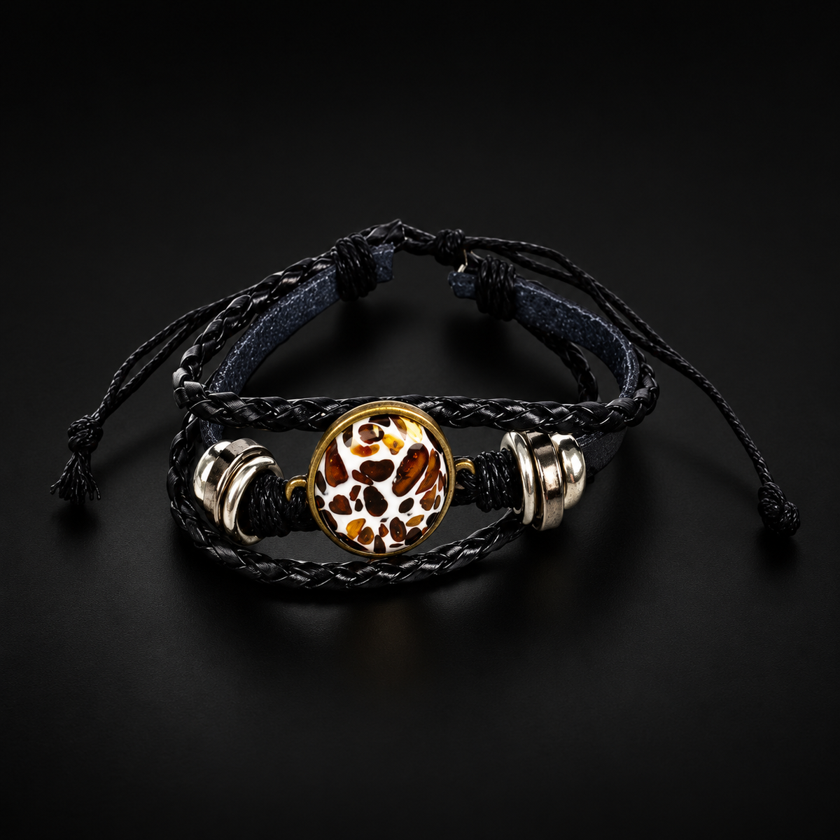 KIZIMA amber mosaic oval and black leather adjustable bracelet on a black studio background.