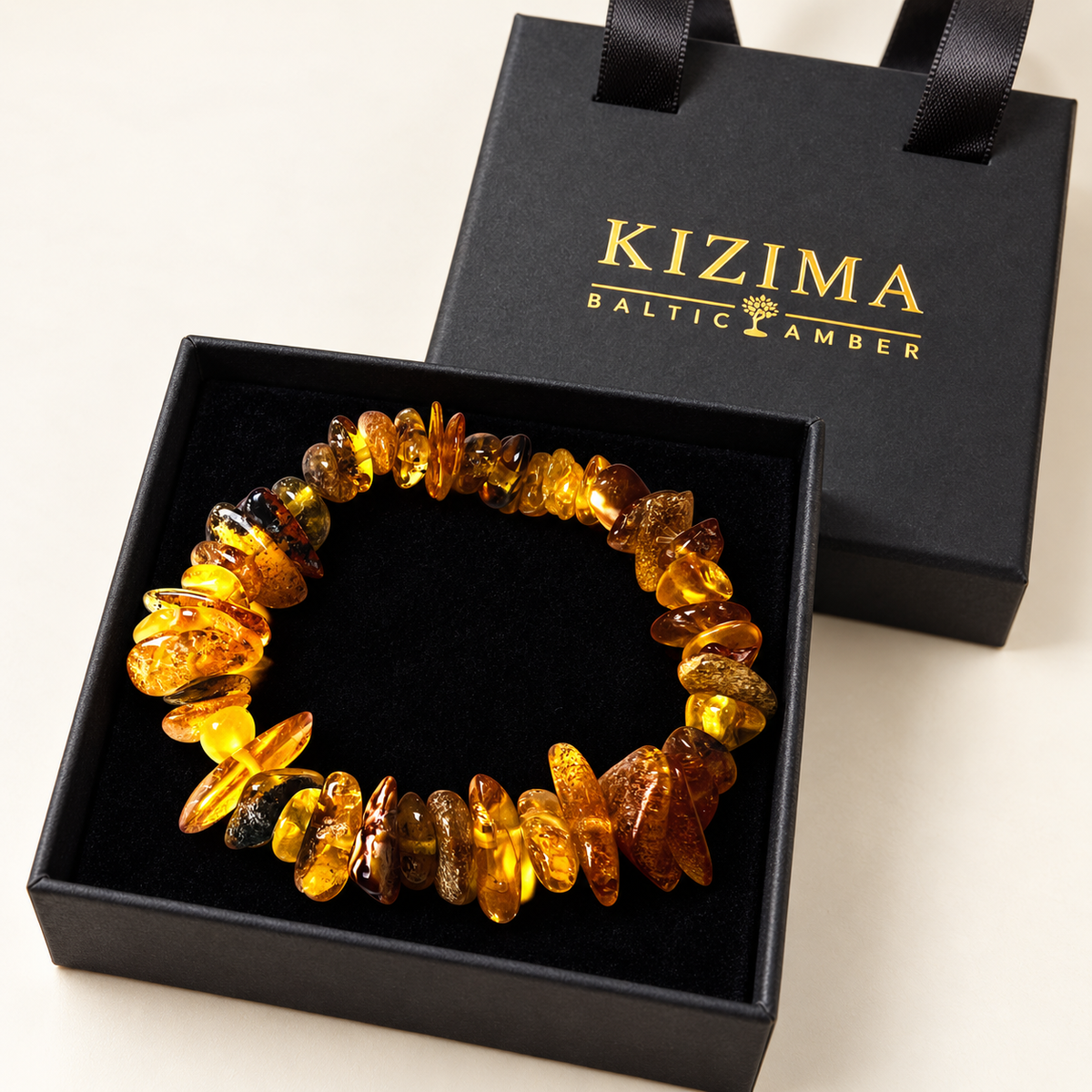 KIZIMA 3N0200q14.80 amber chip bracelet resting on clean black velvet in its gift box