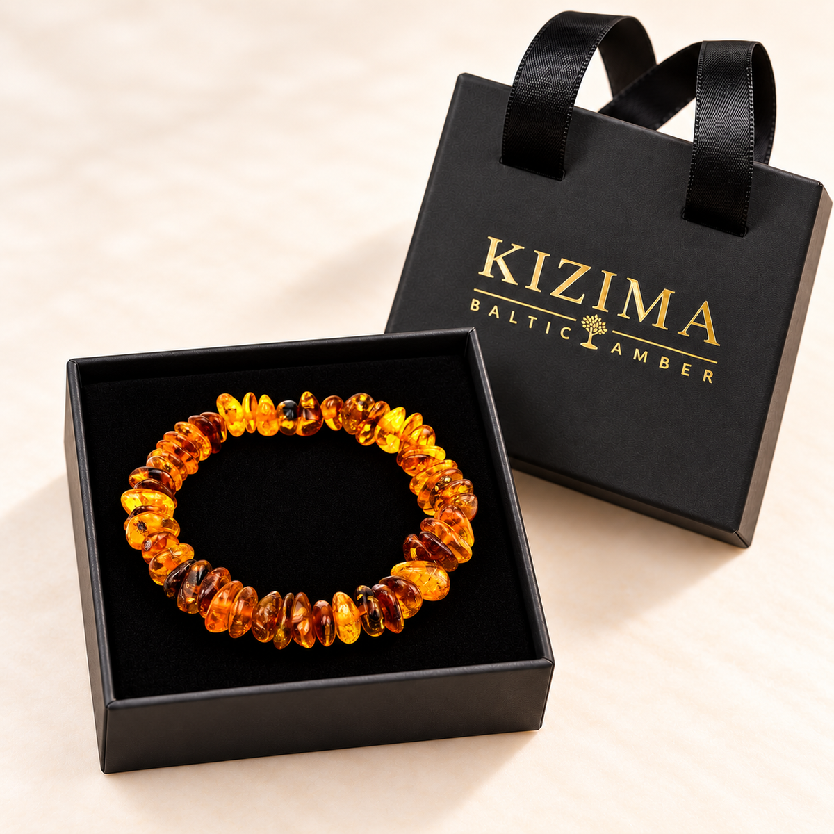 Amber chip stretch bracelet resting on clean black velvet in its KIZIMA gift box