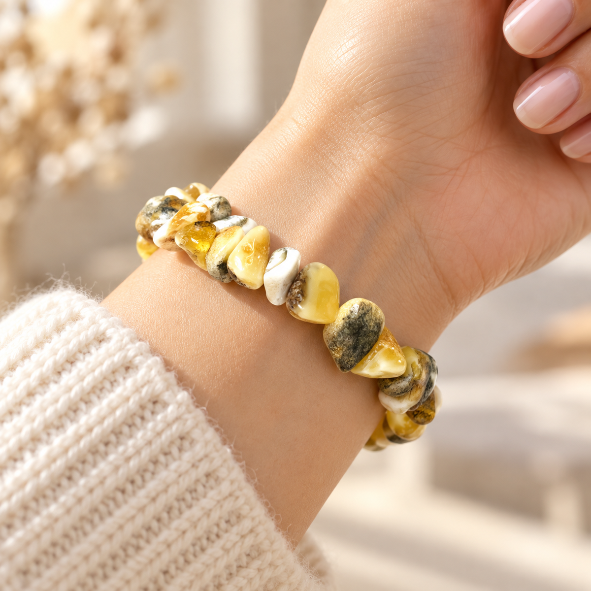 KIZIMA 3N0200q17.85 cream and mottled amber chip bracelet worn on a woman's wrist