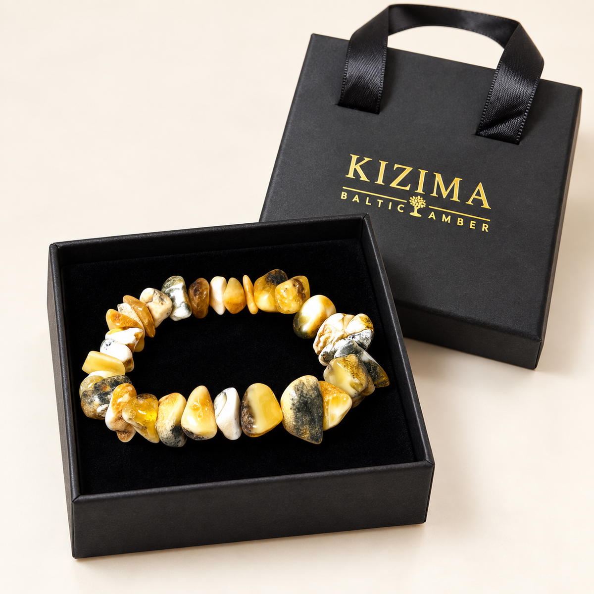 KIZIMA 3N0200q17.85 cream and mottled amber chip bracelet on clean black velvet in its KIZIMA gift box