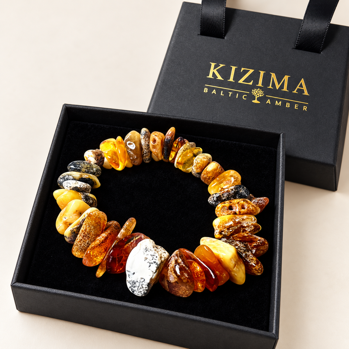 KIZIMA 3N0200q20.40 multicolored amber chip bracelet on clean black velvet in its KIZIMA gift box