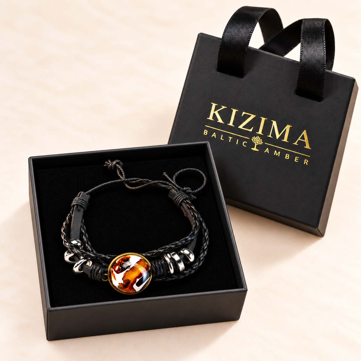 KIZIMA amber and black leather bracelet displayed on pristine black velvet in the branded gift box.