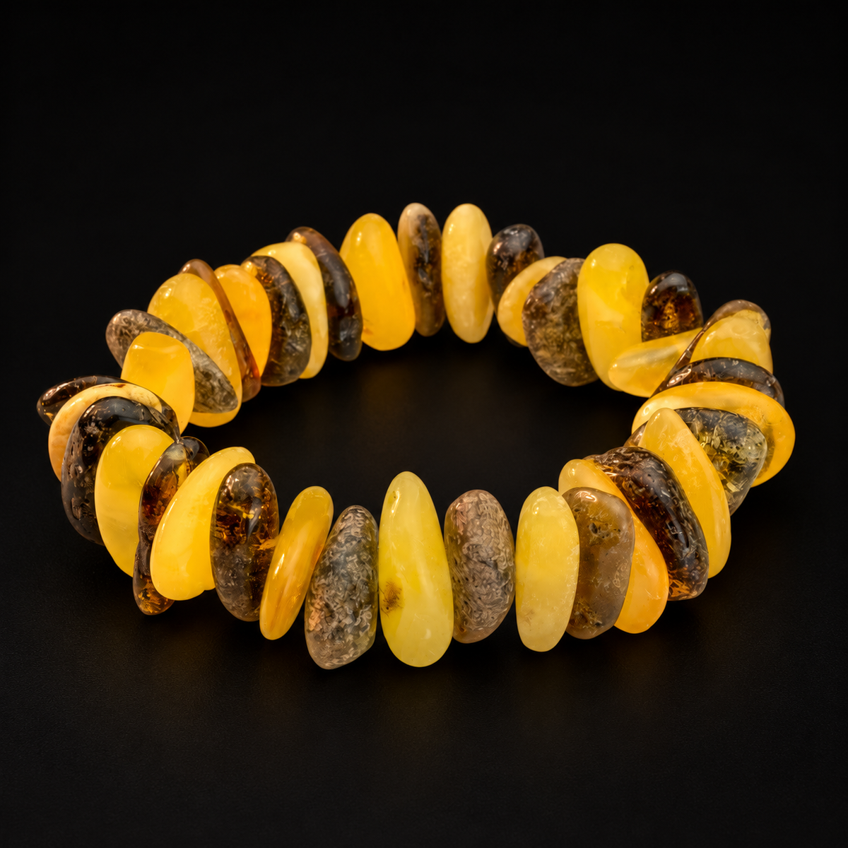 KIZIMA 3N0250q17.31 yellow and dark amber chip bracelet on a black studio surface