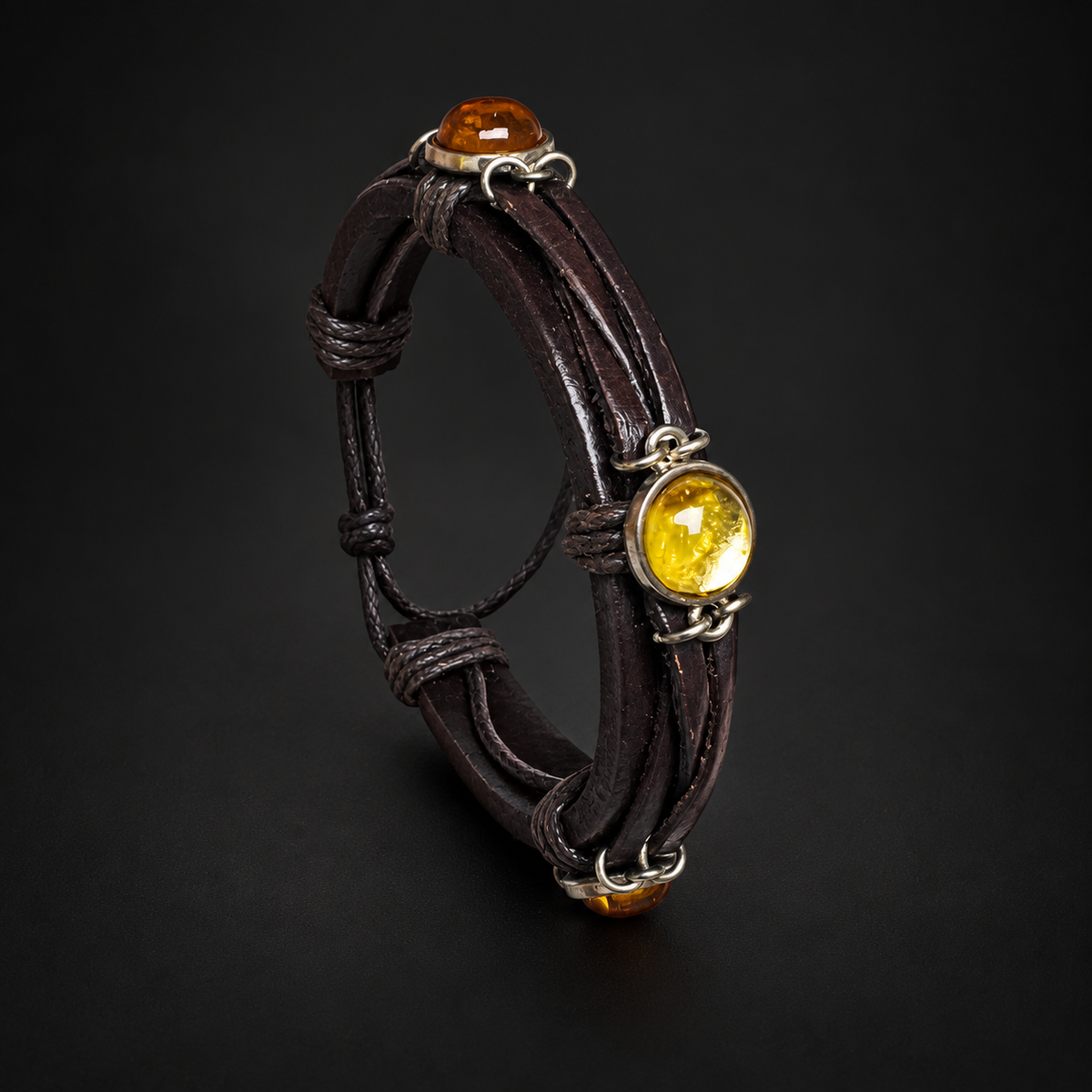 KIZIMA 3N0350mix brown leather bracelet with yellow and cognac amber cabochons under soft black studio lighting