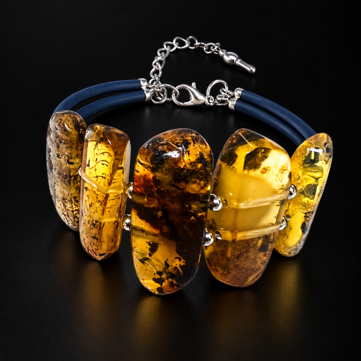 KIZIMA 3N0350q12 five-slab amber bracelet with navy cords and silver-tone clasp on a black studio surface