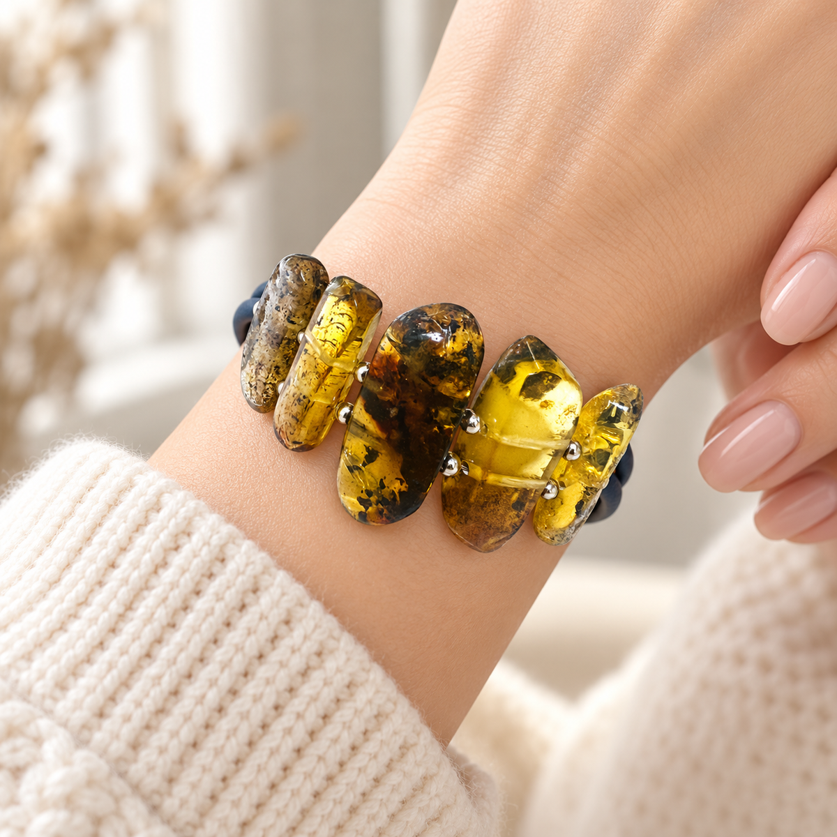 Five irregular amber slabs of KIZIMA 3N0350q12 bracelet worn around a woman's wrist