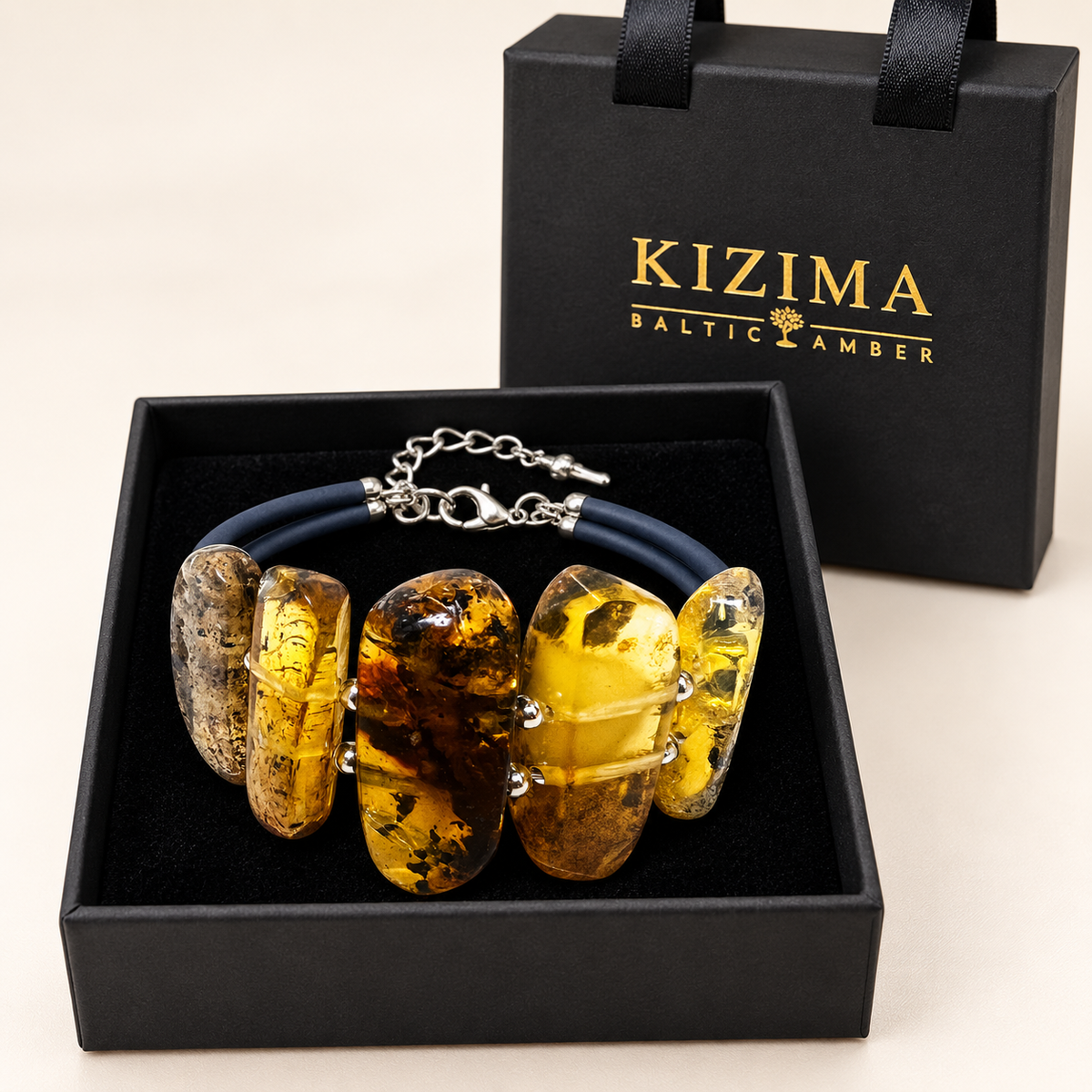 KIZIMA 3N0350q12 amber and navy cord bracelet presented on clean black velvet in its branded gift box