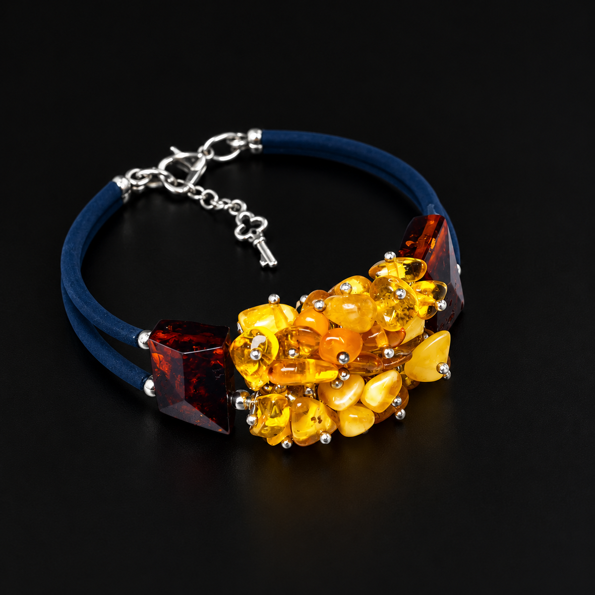 KIZIMA 3N0500q13.5 yellow amber cluster bracelet with dark cognac blocks and double navy cord on a black studio surface