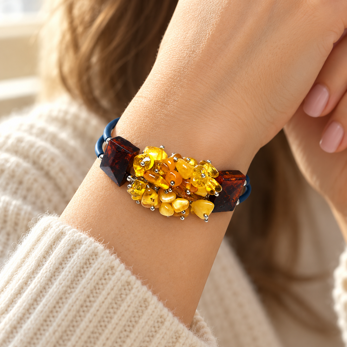 KIZIMA 3N0500q13.5 yellow amber cluster bracelet with dark cognac blocks and double navy cord worn on a woman's wrist