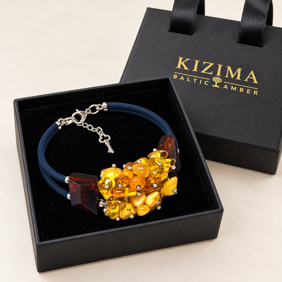 KIZIMA 3N0500q13.5 yellow amber cluster bracelet with dark cognac blocks and double navy cord on clean black velvet in its KIZIMA gift box