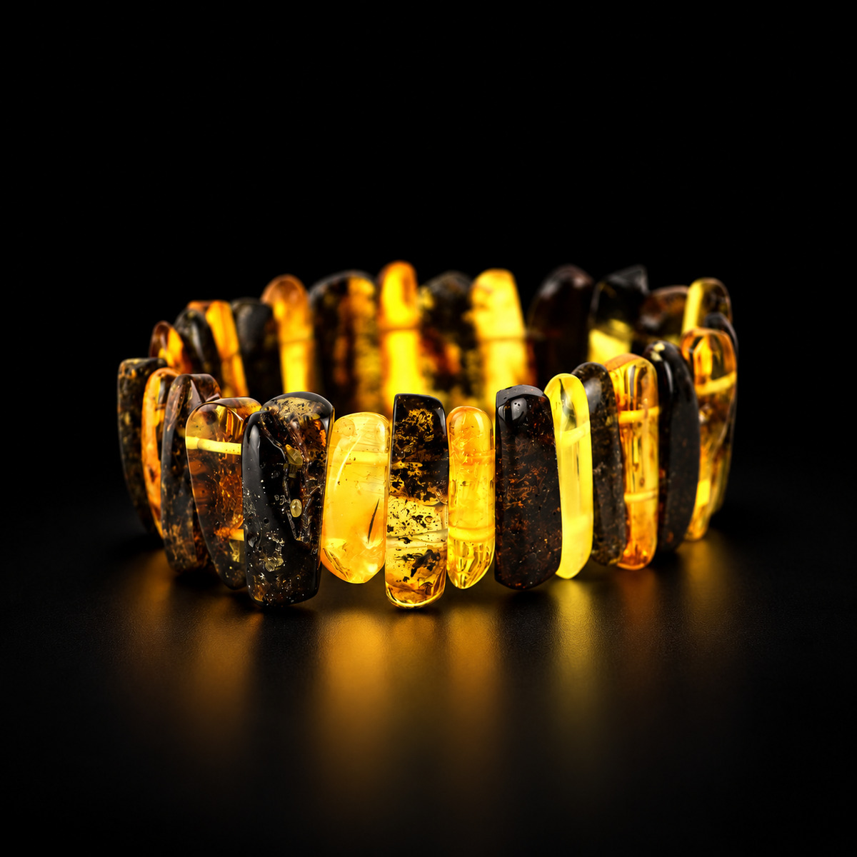 KIZIMA alternating honey and dark amber bar stretch bracelet in premium black studio light.