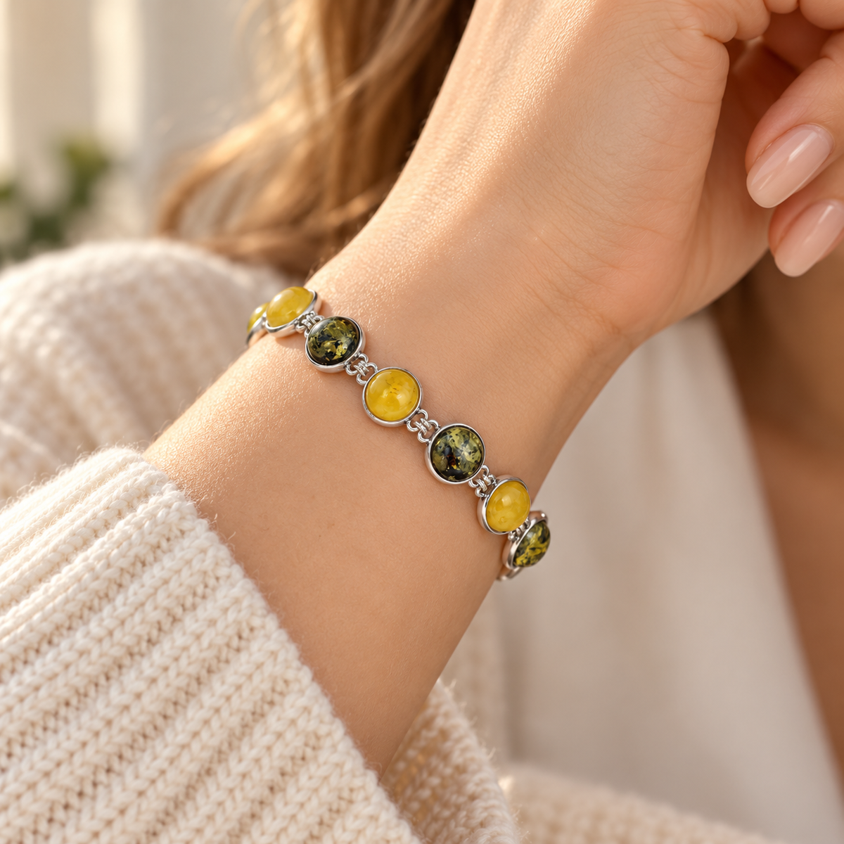 KIZIMA 3N0900q12-1.1 bracelet with eight alternating yellow and green amber cabochons worn around a woman's wrist