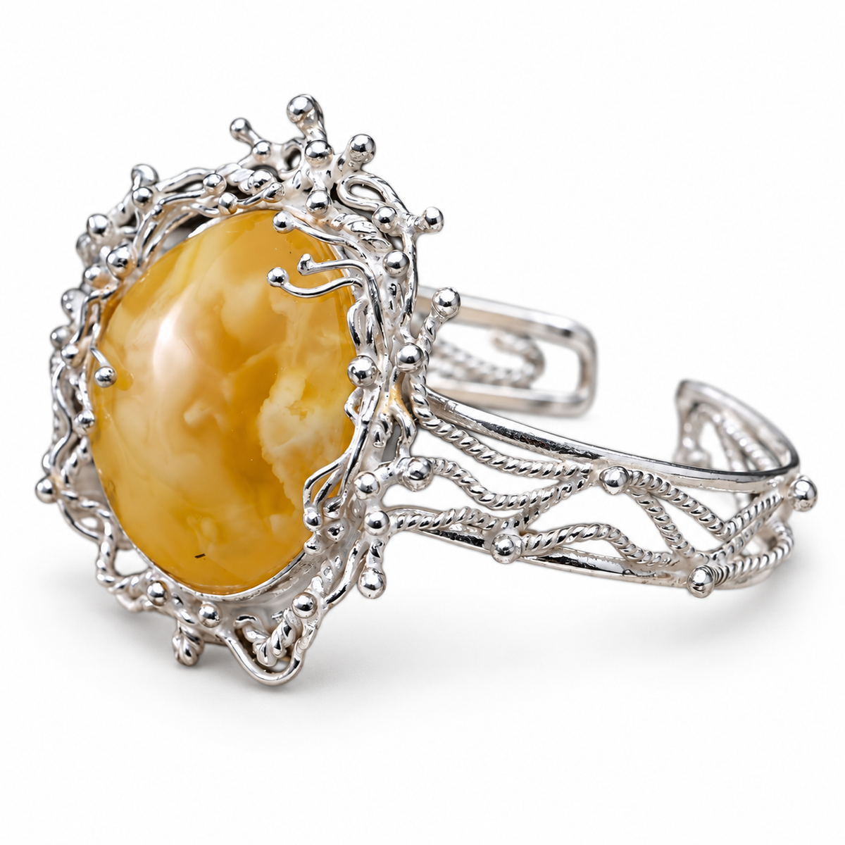 KIZIMA marbled golden amber cabochon in silver-tone branching open cuff on pure white background.