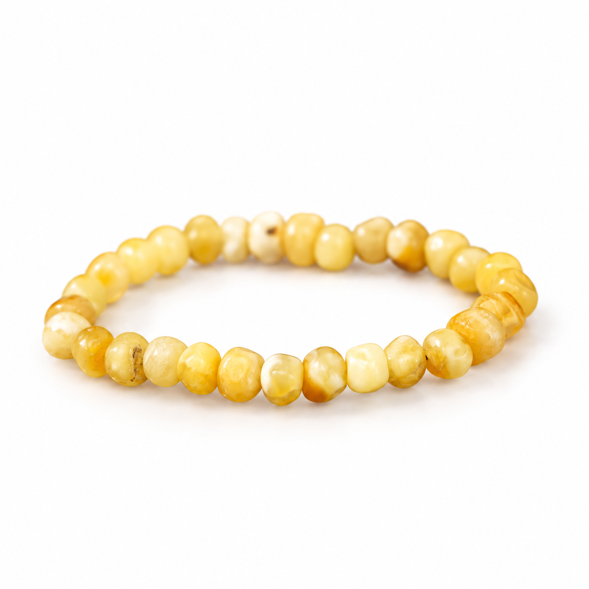 KIZIMA creamy yellow amber rounded nugget bracelet on a pure white background.