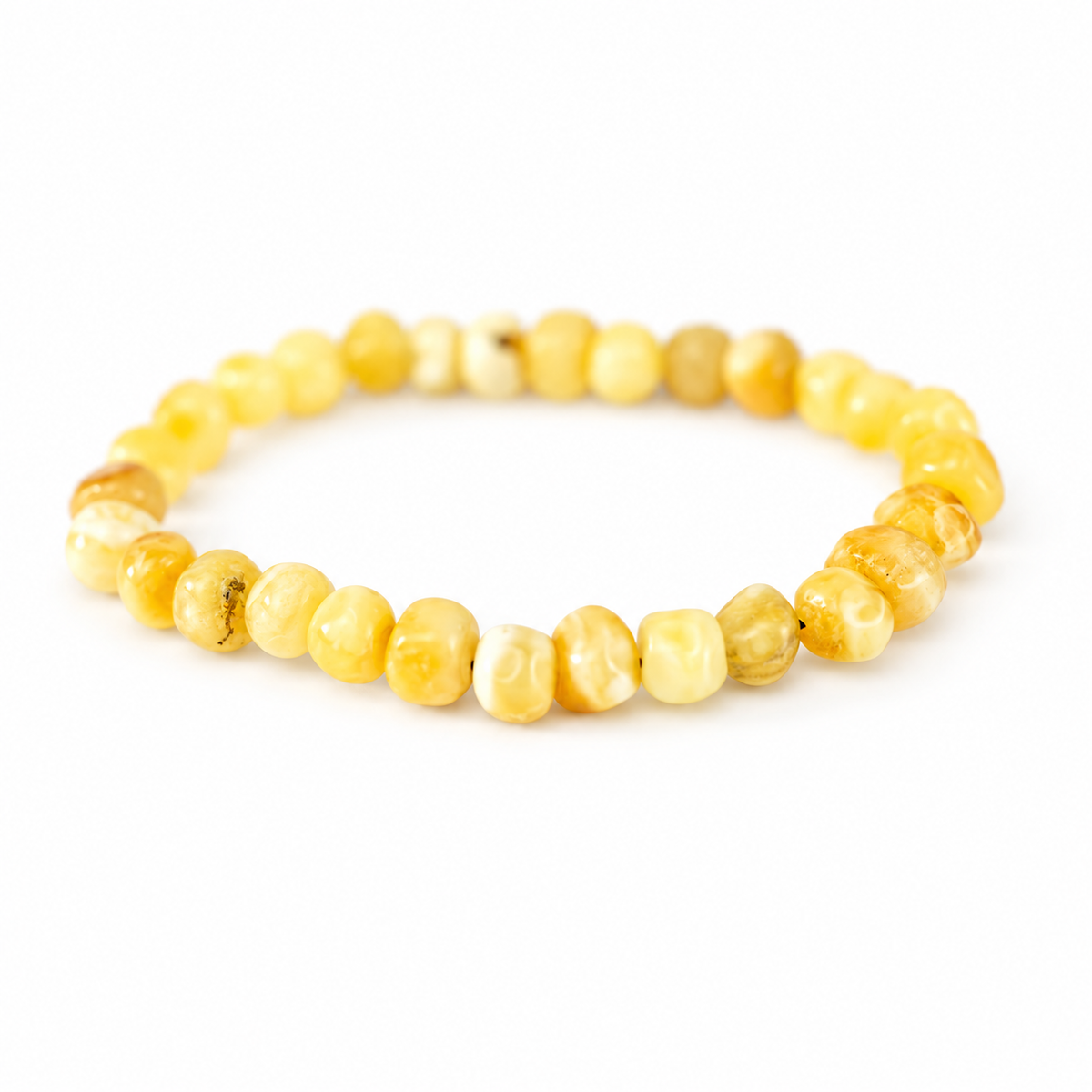 Single-strand KIZIMA yellow amber bracelet with rounded irregular beads on a pure white background.