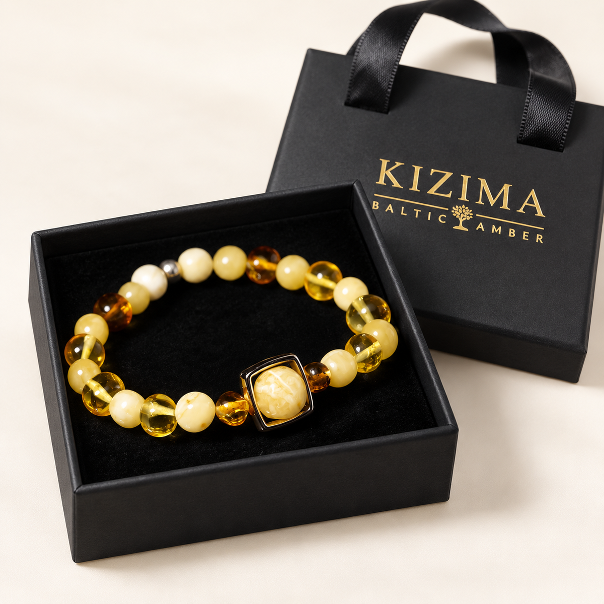 Cream and honey amber square-frame bracelet on clean black velvet in a KIZIMA gift box.
