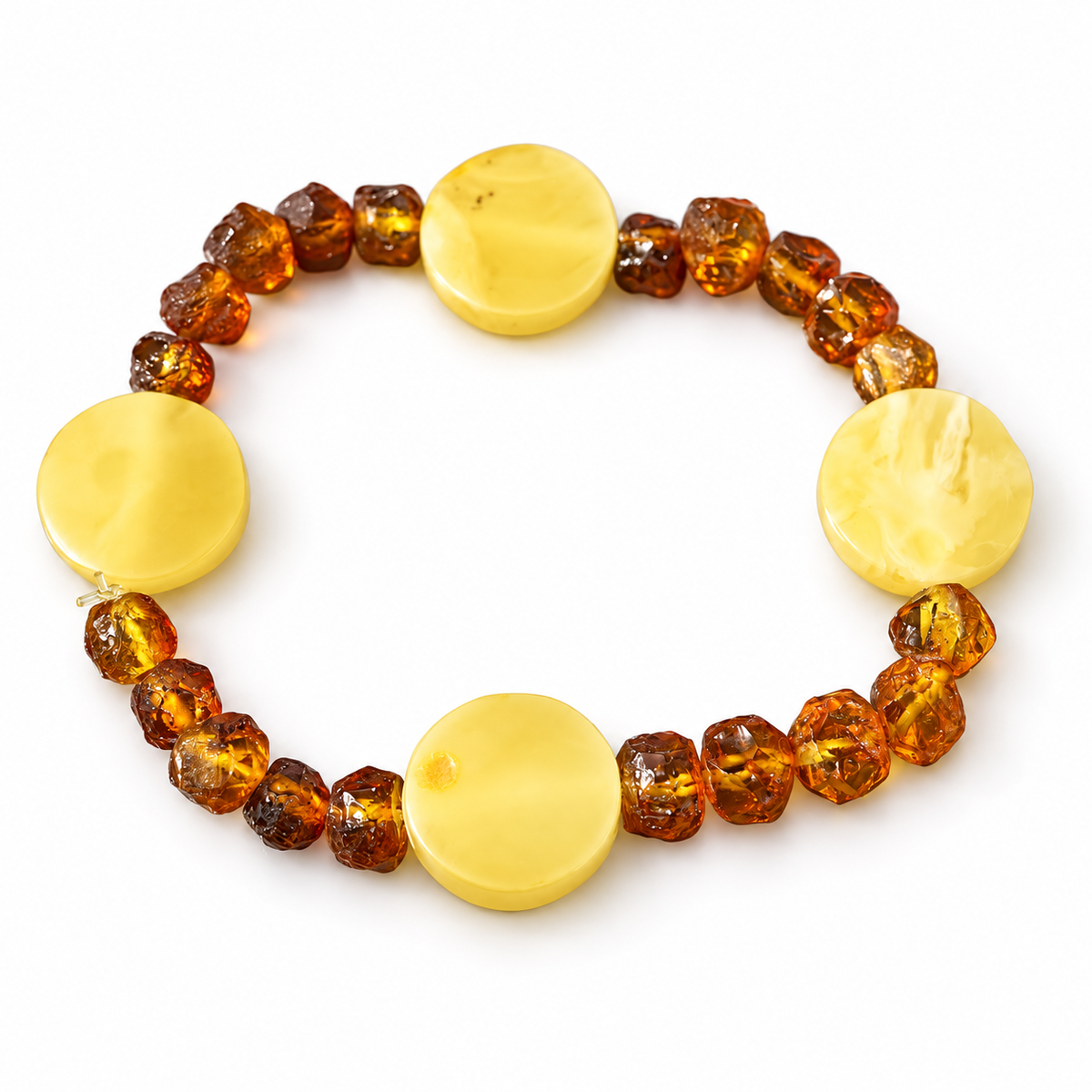 Four polished yellow amber discs separated by groups of rough cognac beads on white.