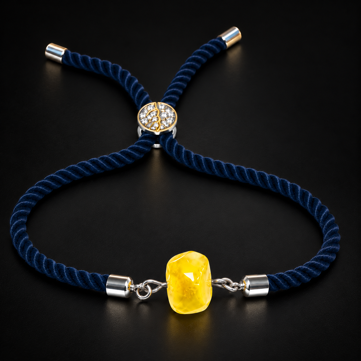 KIZIMA lemon-yellow amber bracelet with navy twisted cord and silver-colored fittings in black studio light