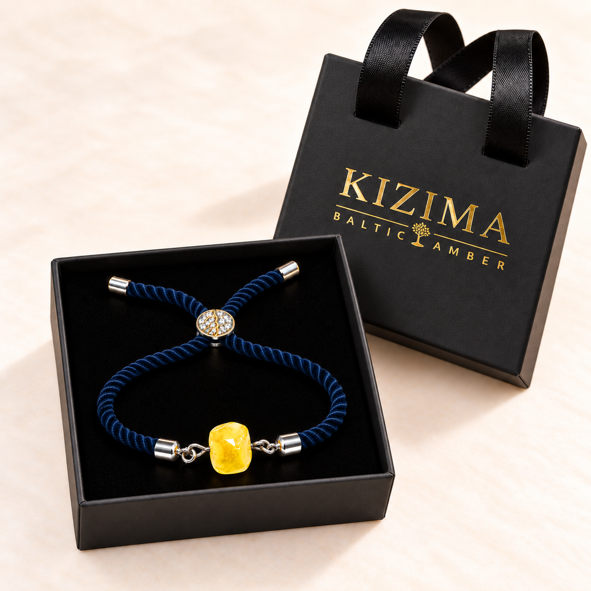 KIZIMA yellow amber cord bracelet on black velvet inside its branded gift box