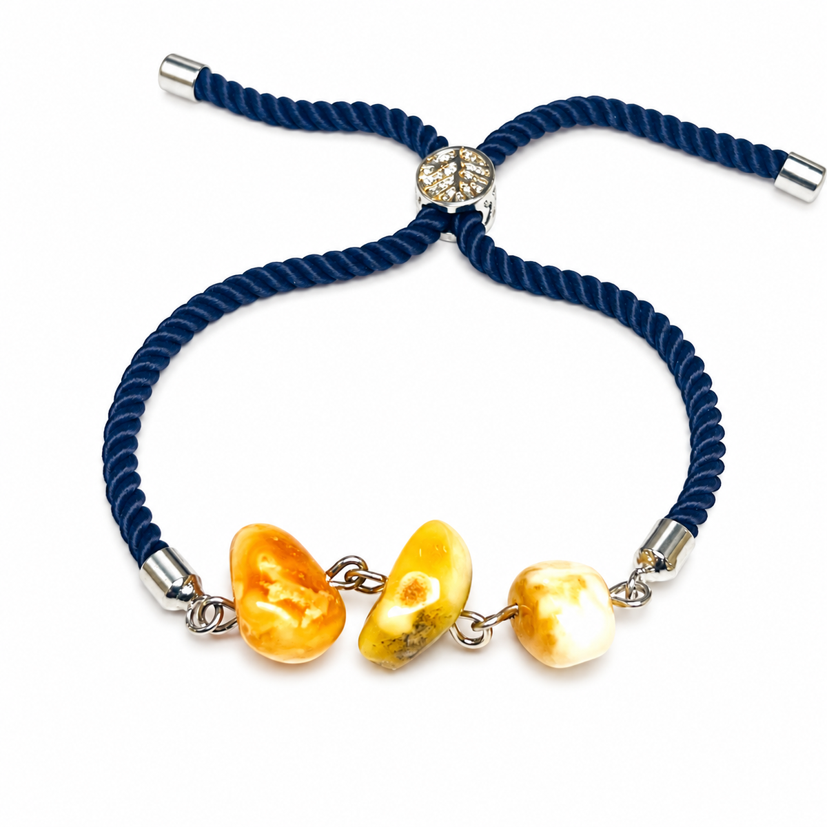 Three irregular amber beads and silver-tone links of KIZIMA 3P0400q4.79 isolated on pure white